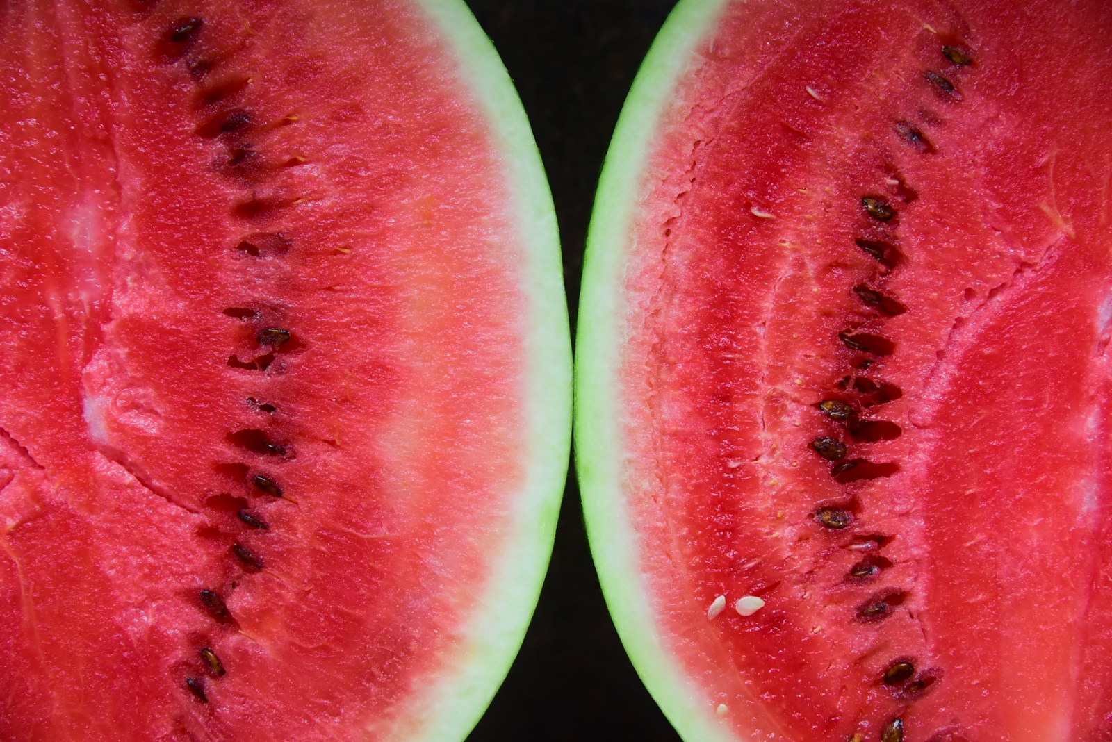 sliced watermelon on black surface