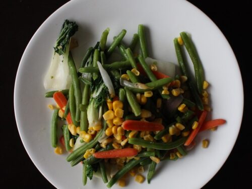 corns and sliced carrots on white plate