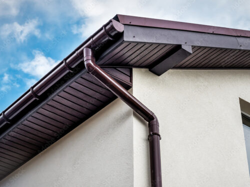 Lateral coated metal panel, rain gutter and rain water pipe at a roof