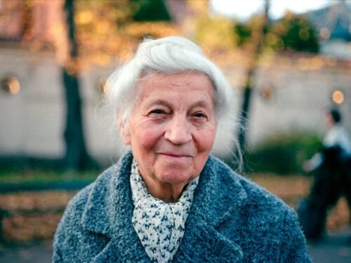 An old woman is walking down the street