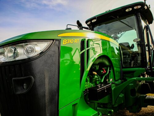 a close up of the front of a green tractor