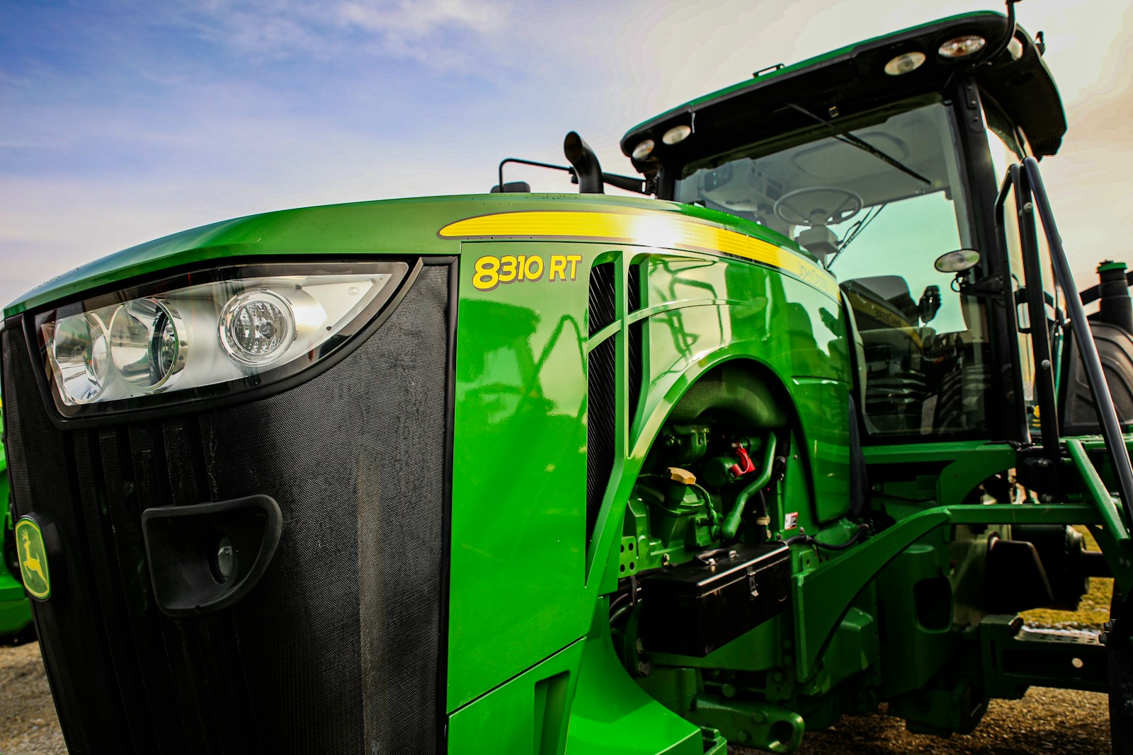 a close up of the front of a green tractor