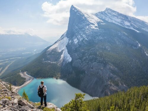 aerial photography of man standing on hill