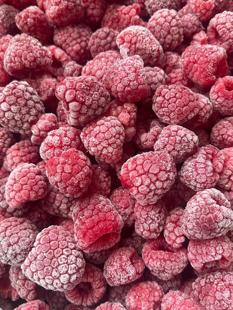 Frozen raspberries close-up background