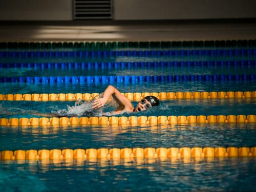 person diving in pool