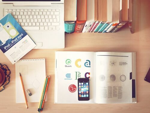 pencils and smartphone on top of books