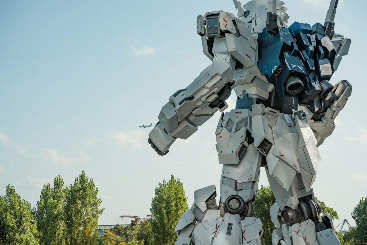 Giant white robot statue with trees and sky