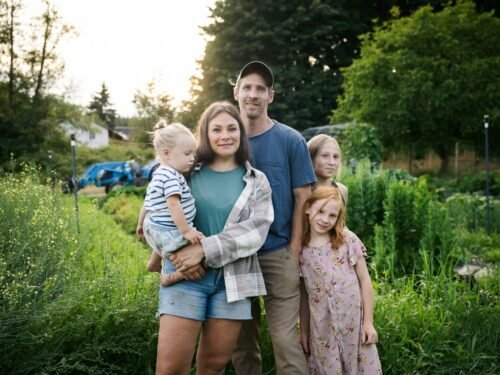 Family posing in a lush garden setting