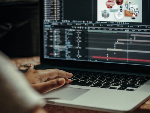 person using macbook pro on table