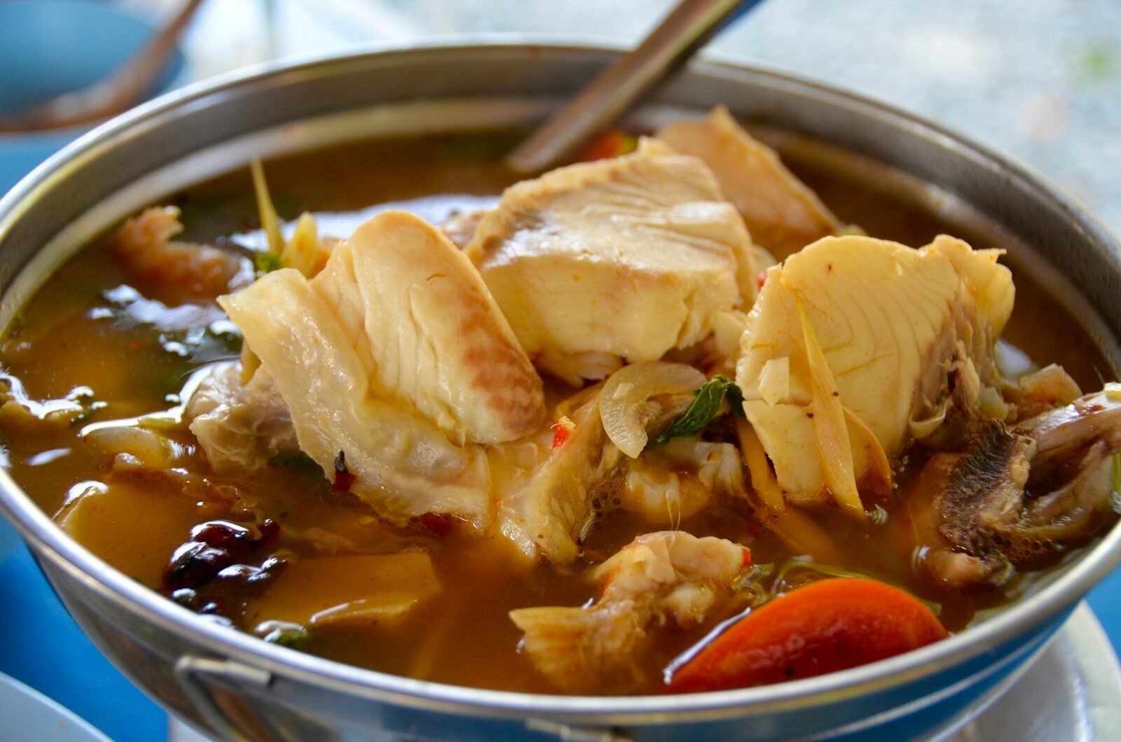 A metal bowl filled with meat and vegetables