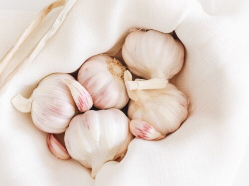 five garlic on white textile