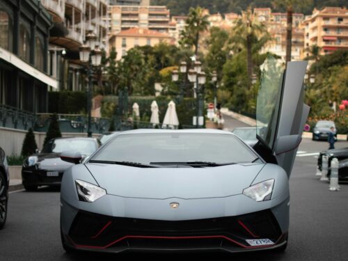 a white sports car parked on the side of a street