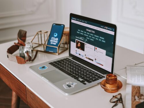 a laptop computer sitting on top of a wooden desk