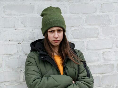 woman in green knit cap and green jacket