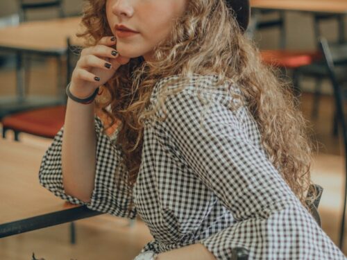 woman sitting on ladder chair beside table