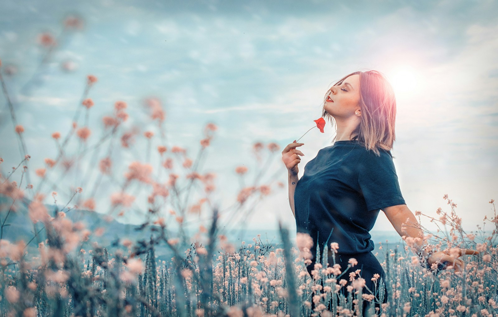 woman holding red flower