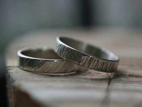 silver ring on brown wooden table