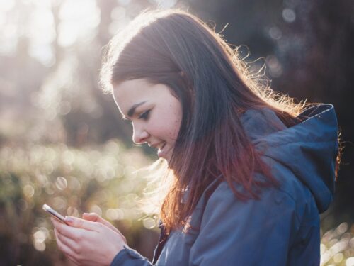 woman holding phone smiling