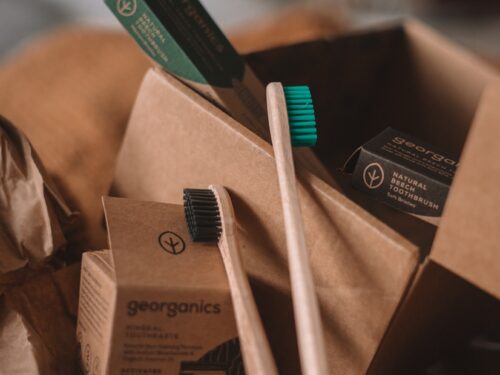 green and white toothbrush on brown carton box