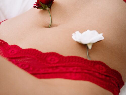 woman in red lace panty lying on bed