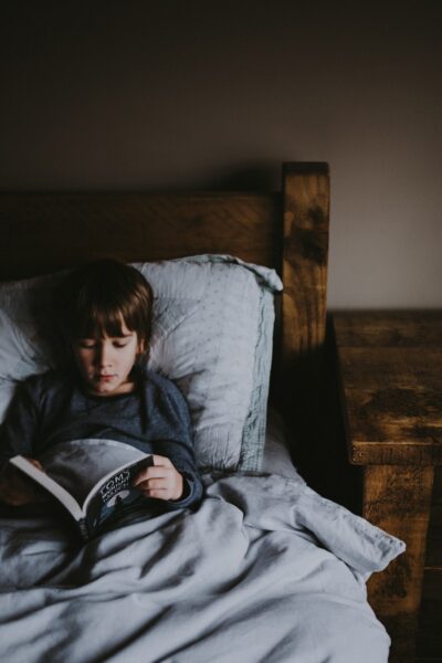 boy reading Tom's book on bed