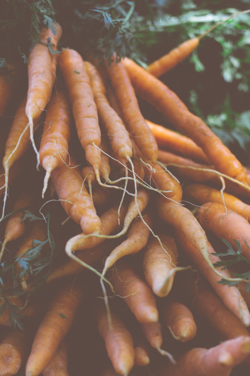 a pile of carrots sitting next to each other