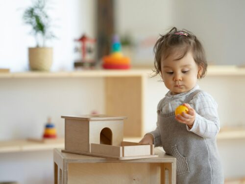 a little girl holding a yellow object