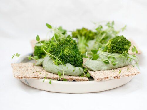 green vegetable on brown wooden round plate