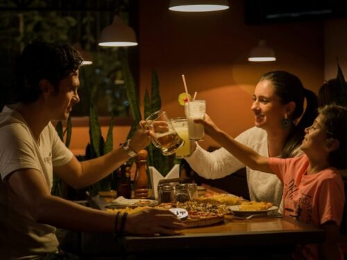 three people having a toast on table