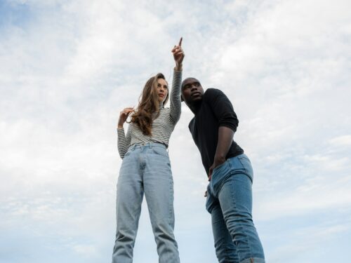 photography of woman pointing her finger near an man