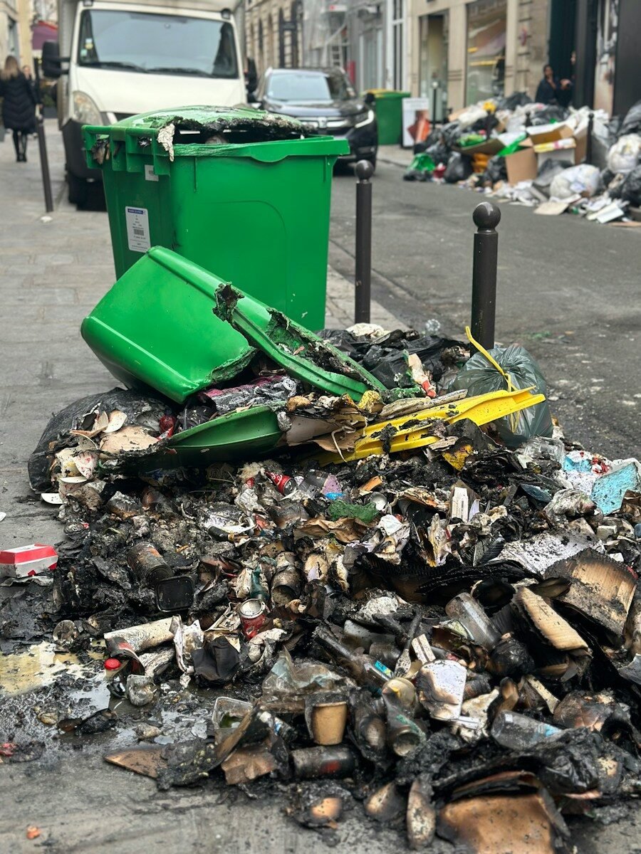 a pile of garbage sitting on the side of a road