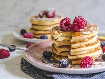 pancakes with berries on white ceramic plate