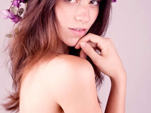 topless woman with purple flower on her head